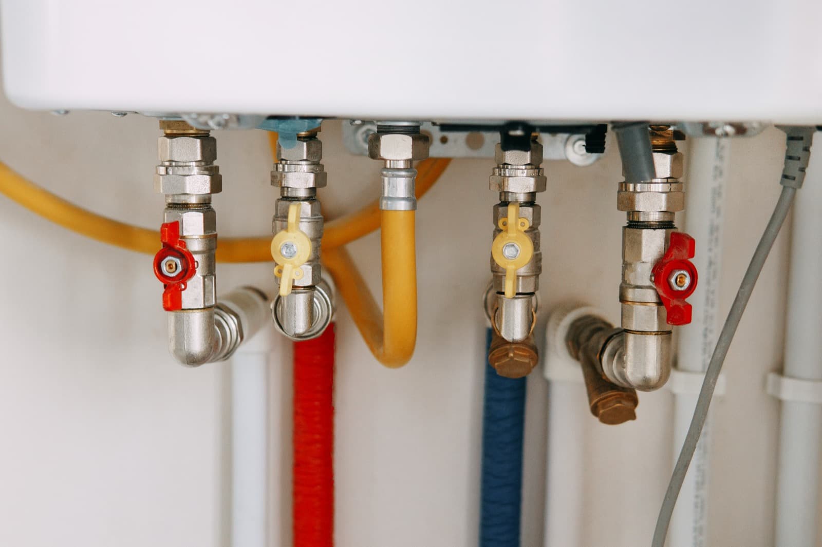 Close-up of water heater pipes and shutoff valves