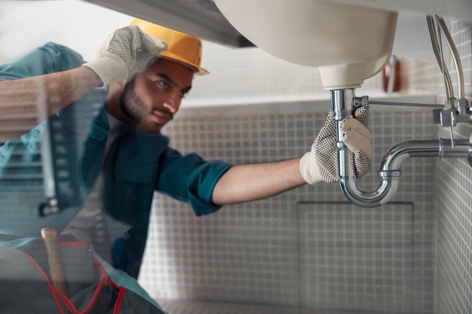 Plumber repairing a bathroom faucet in a Flower Mound home