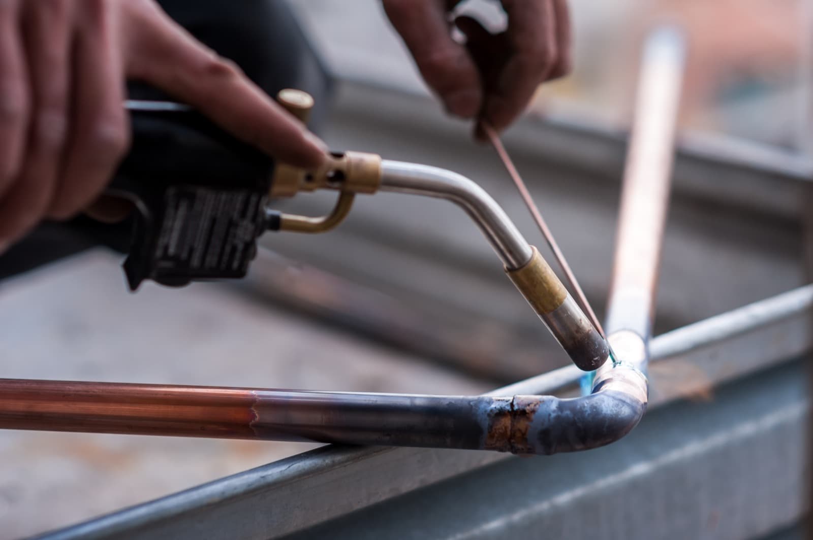 Plumber soldering copper pipes during a home repipe