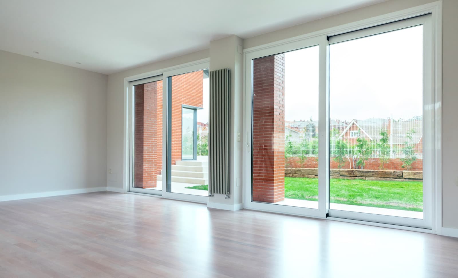 Tidy garden seen through a home's sliding glass doors