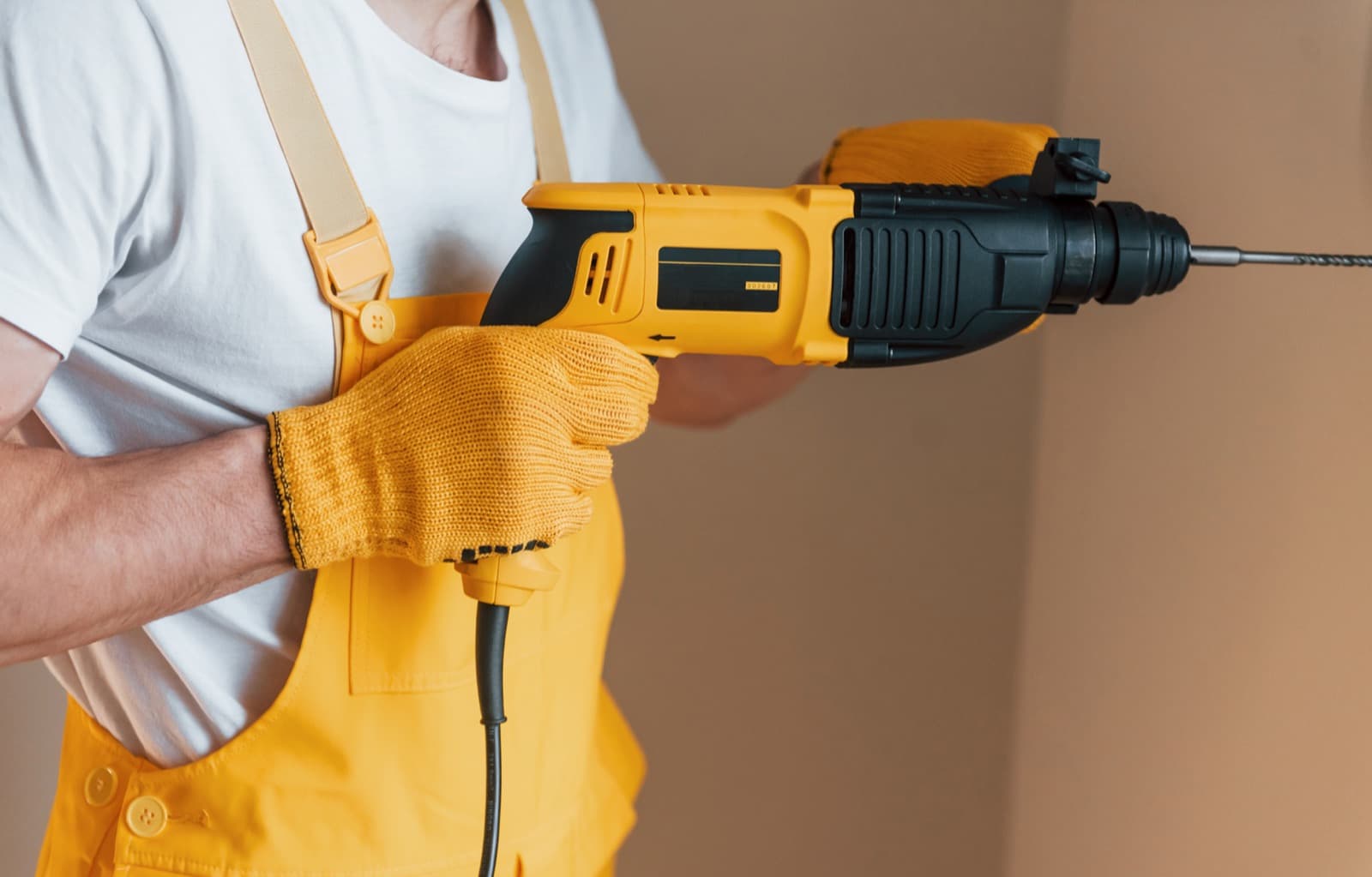Maintenance technician in uniform working inside a home