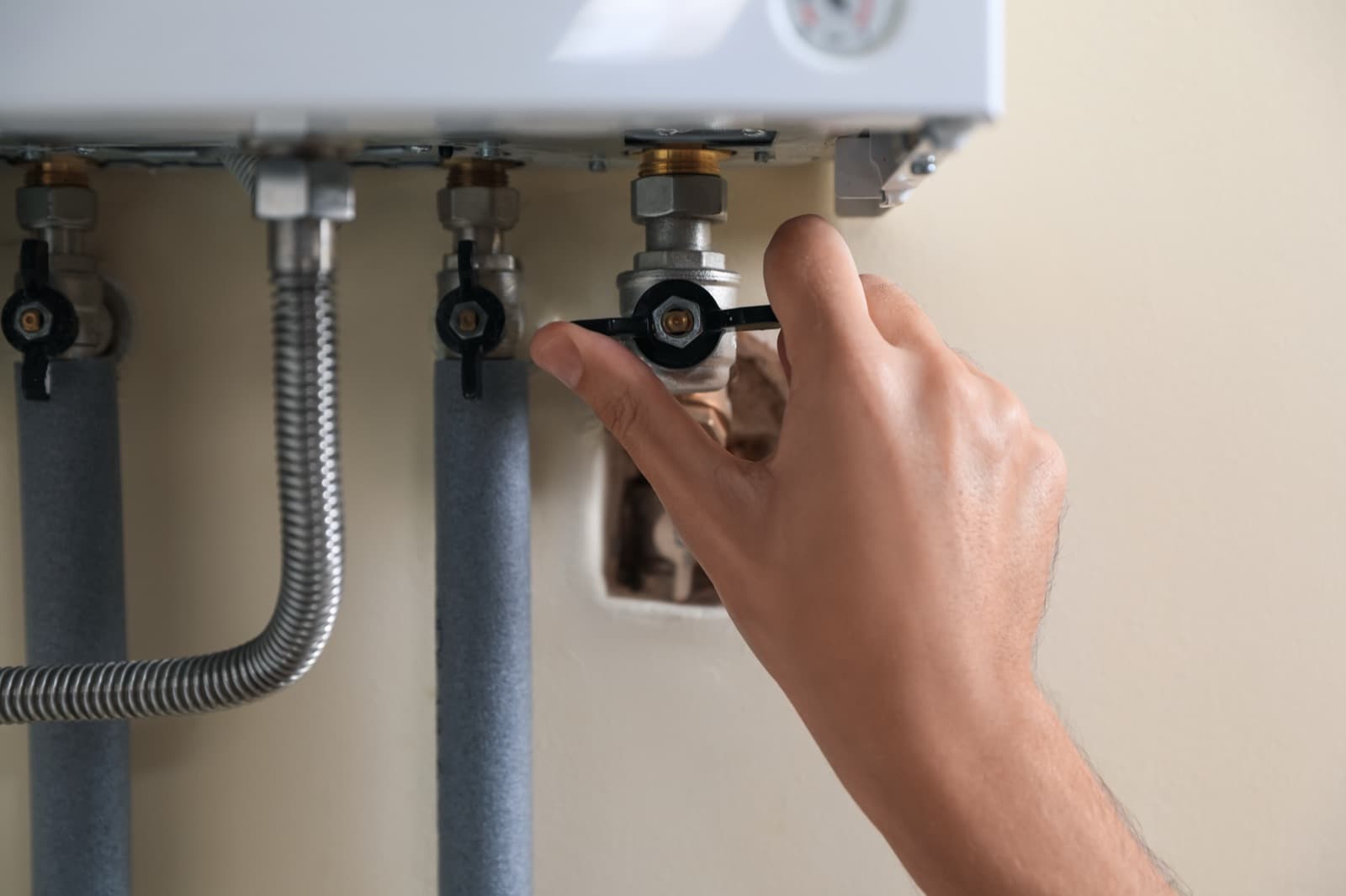 Plumber adjusting a pressure-reducing valve in an Allen home